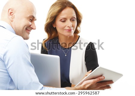 Portrait of businessman holding hands digital tablet and presenting his idea to executive businesswoman. Business team working together with laptop and digital tablet. Isolated on white background.