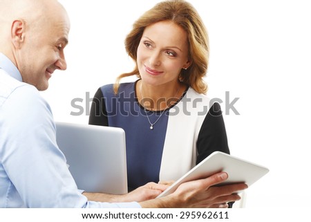 Portrait of businessman holding hands digital tablet and presenting his idea to executive businesswoman. Business team working together with laptop and digital tablet. Isolated on white background.