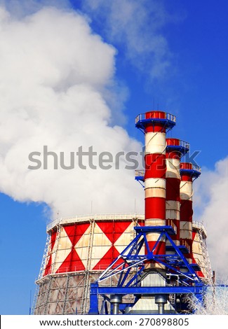 Smoking pipes of gas-turbine plant against blue sky