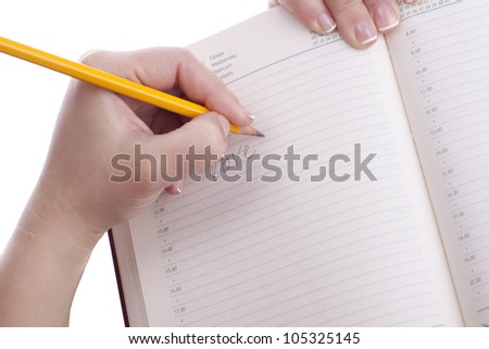 Woman writing I love you in a notebook.