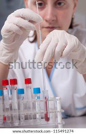 Woman in coat is doing laboratory research.