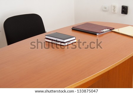 Desk with documents and books. Meeting room interiror.