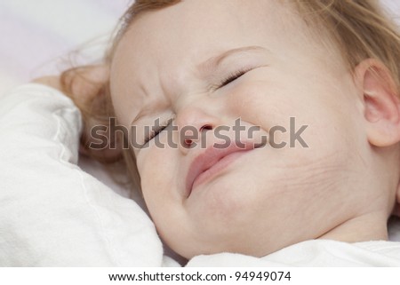 Baby' waking up in bed unhappy