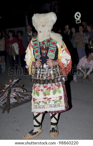 ARBANASSI, BULGARIA - MARCH 24: Kukeri dance group perform a dance to ward away bad spirits during \