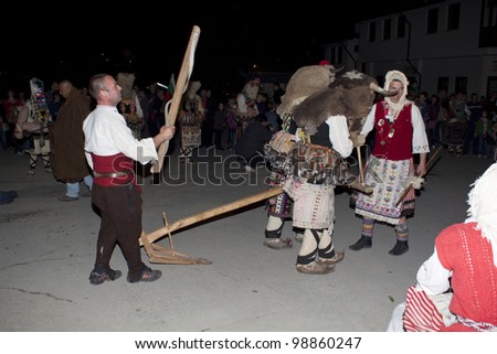 ARBANASSI, BULGARIA - MARCH 24: Kukeri dance group perform a dance to ward away bad spirits during \