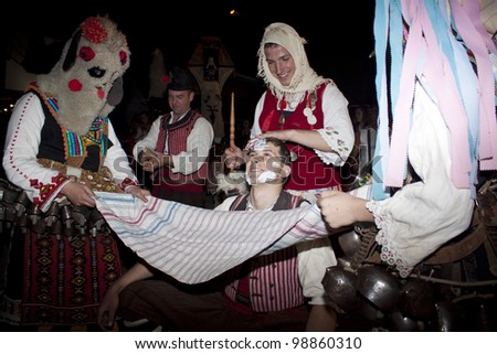 ARBANASSI, BULGARIA - MARCH 24: Kukeri dance group perform a dance to ward away bad spirits during 