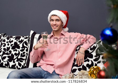 young man sitting drinking champagne in the new year