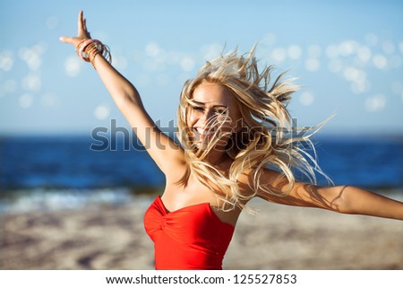 happy young beauty woman on sea beach , birds flying around