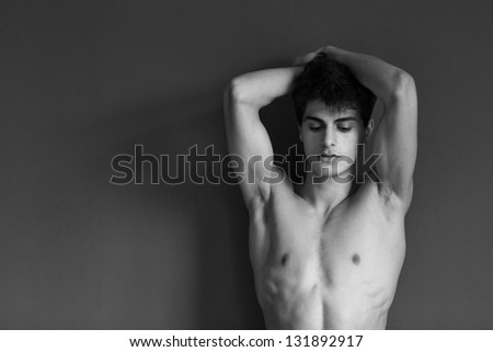Portrait of a well built shirtless muscular male model, black and white