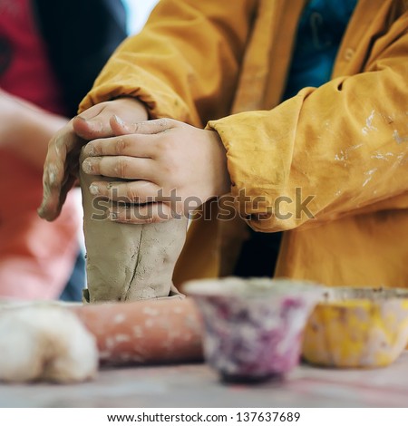 boy teen potter clay bowl working in pottery workshop traditional arts - stock photo