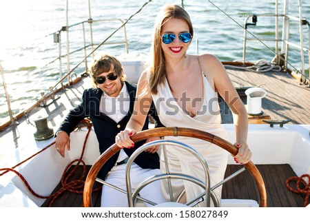 fashion beautiful couple in romantic trip on yacht fashion beautiful couple in romantic trip on yacht