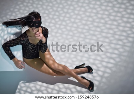 Artistic portraits of fashion woman in mask with shadows on her