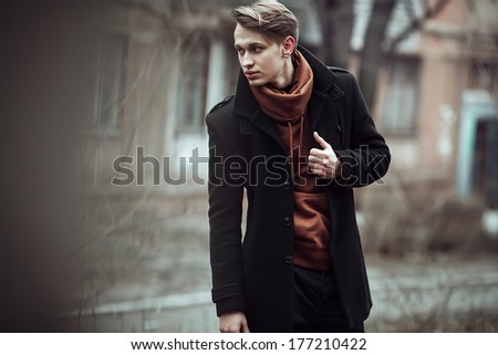 fashion portrait of a stylish man posing outside, autumn time