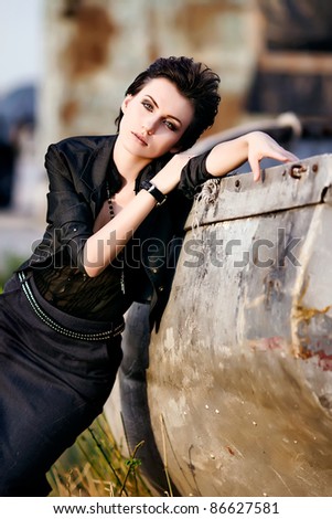 Young beautiful fashion model with hair and make-up professionally done outdoors