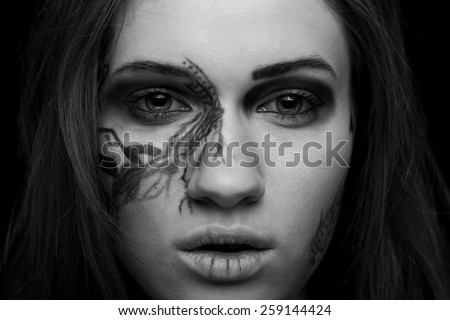 Black and white portrait of a girl with fantasy make up