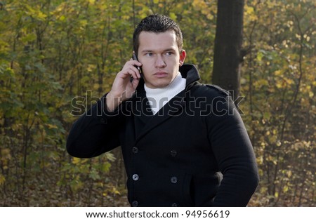 The young man speaks by a telephone