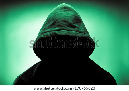 Man wearing hood with face in shadow