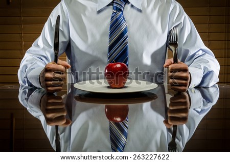 Man with shirt and tie with an apple and utensils