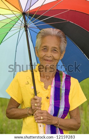 old Asian woman with colorful umbrella