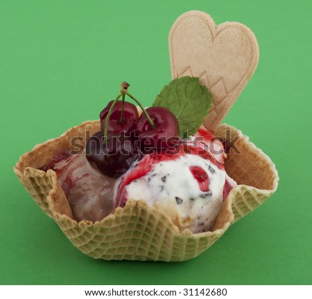 Fruit sundae with cherry on waffle, with waffle as a cup