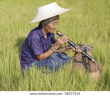 old woman Asia smoking opium pipe