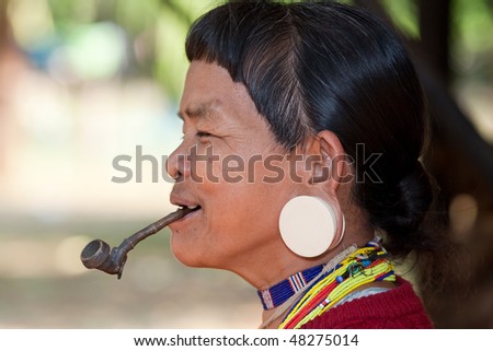 old woman with pipe in Asia