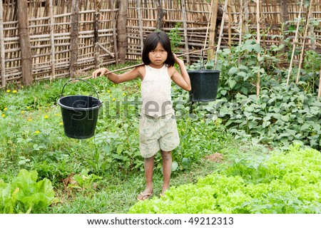Asian girl carry water bucket