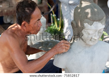 restore buddhist figure, old Asian man with his craft