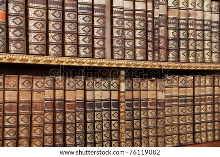 old antique books, with hardcover in a row on shelf