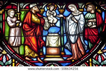BRUSSELS JUNE 22 Simeon and Jesus in the Temple from windowpane in st Michael s gothic cathedral on June 22 2012 in Brussels. BRUSSELS JUNE 22 Simeon and Jesus in the Temple from windowpane in st Michael s gothic cathedral on June 22 2012 in Brussels.