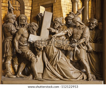 BRUSSELS - JUNE 24: Jesus falls under cross. Relief from Cross way in Saint Antoine church on June 24, 2012 in Brussels.