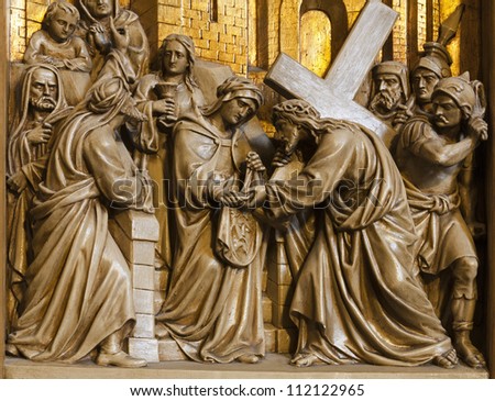 BRUSSELS - JUNE 24: Jesus meets the Veronica. Relief from Cross way in Saint Antoine church on June 24, 2012 in Brussels.