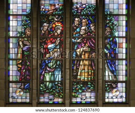 BRUSSELS - JUNE 22: Jesus rescues the sinful woman. Windowpane in National Basilica of the Sacred Heart built between years 1919 - 1969 on June 22, 2012 in Brussels.