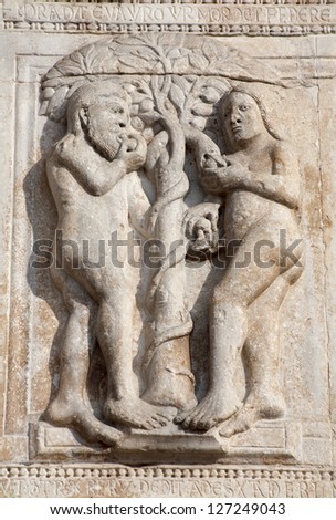 VERONA - JANUARY 27: Relief of Adam and Eva from facade of romanesque Basilica San Zeno. Reliefs is work of the sculptor Nicholaus and his workshop on January 27, 2013 in Verona, Italy.