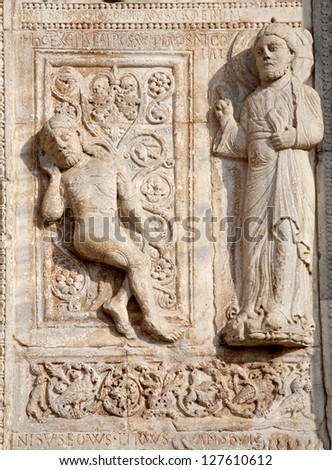 VERONA - JANUARY 27: Relief of creation of Adam from romanesque Basilica San Zeno. Relief is work of the sculptor Nicholaus and his workshop on January 27, 2013 in Verona, Italy.