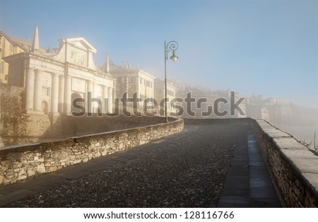 Bergamo - San Giacomo gate to upper town - Porta San Giacomo in morning light and fog in winter