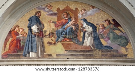 BERGAMO - JANUARY 29: Madonna with the child and holy John from the cross and Theresia of Avila from portal of st. Stephen and st.Bartholomew church on January 29, 2013 in Bergamo, Italy.