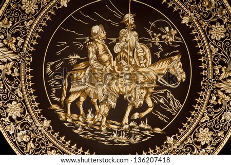 TOLEDO - MARCH 8:  Detail of typical damascening plate with the Don Quixote and Sancho Panza. Traditional handicraft with metal on March 8, 2013 in Toledo, Spain.