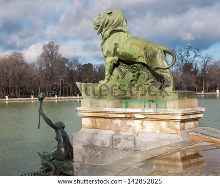 MADRID - MARCH 9: Detail of lion statue in front of Monument of Alfonso XII in Buen Retiro park by architect Jose Grases Riera from year 1902 in March 9, 2013 in Spain.