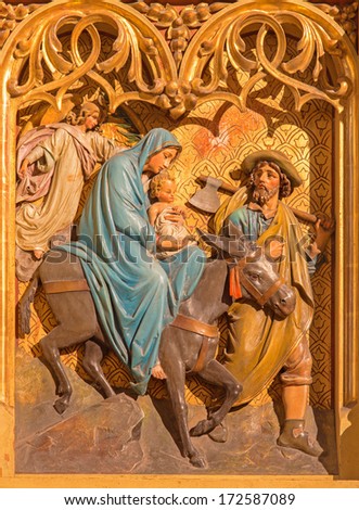 BRATISLAVA, SLOVAKIA - JANUARY 14, 2014: Flight of hl. Family to Egypt scene. Carved relief from 19. cent.  by Ferdinand Prinoth from St. Ulrich on gothic side altar in st. Martin cathedral.