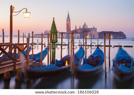 Venice - Gondolas and San Giorgio Maggiore church in background in morning dusk.