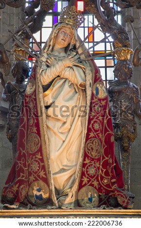 MECHELEN, BELGIUM - JUNE 14, 2014: The carved statue of the Lady of Sorrow in the coat in church Our Lady across de Dyle.
