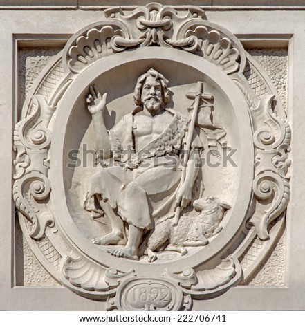 BRUGES, BELGIUM - JUNE 13, 2014: The relief of st. John the Baptist on he facade of baroque Carmelites church.