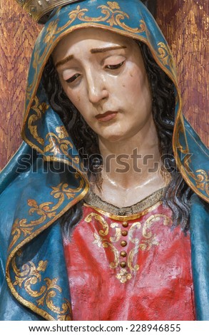 SEVILLE, SPAIN - OCTOBER 28, 2014: The detail of cried Virgin Mary statue in church Iglesia de San Roque.