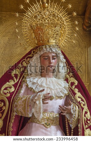 SEVILLE, SPAIN - OCTOBER 28, 2014: The detail of typically vested, cried Virgin Mary statue in church Iglesia de San Roque.