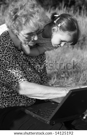 garandmother and grandchild with notebook