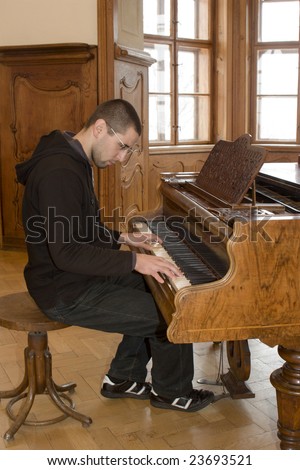 piano player in interior of old casltle
