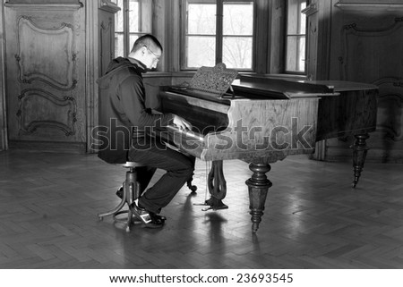 piano player in interior of old casltle