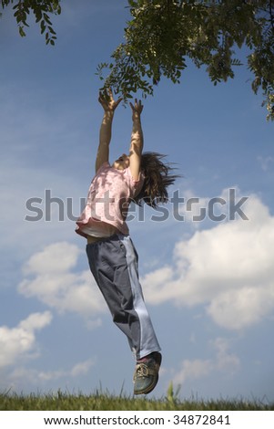 jump of little girl and tree in the spring