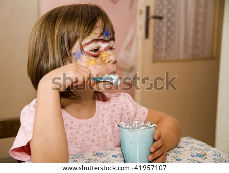 little girl with the mask by eating